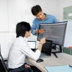 Engineers reviewing code on a monitor: What Product Teams Should Verify Before Wiring In a Public-Record API