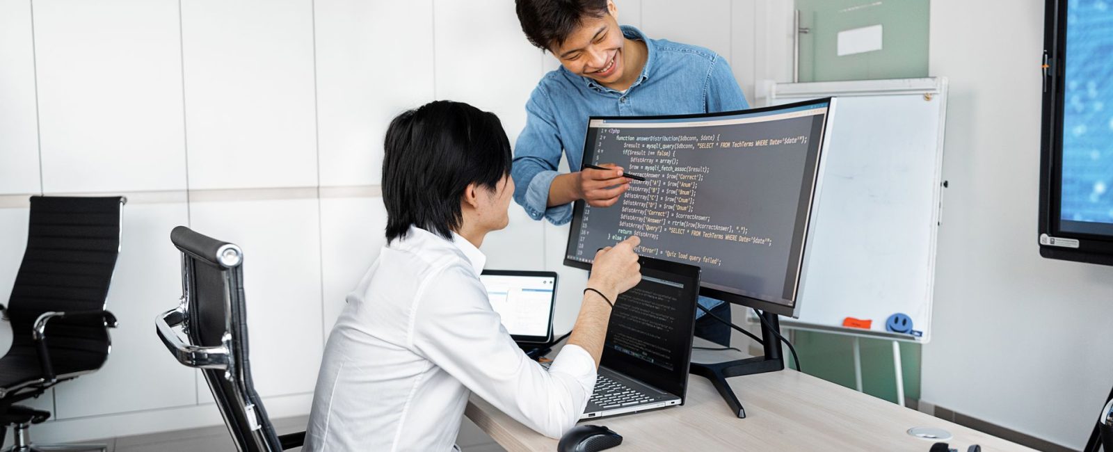 Engineers reviewing code on a monitor: What Product Teams Should Verify Before Wiring In a Public-Record API