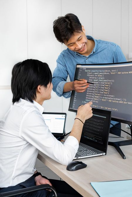 Engineers reviewing code on a monitor: What Product Teams Should Verify Before Wiring In a Public-Record API