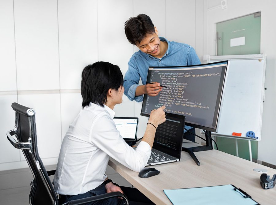 Engineers reviewing code on a monitor: What Product Teams Should Verify Before Wiring In a Public-Record API