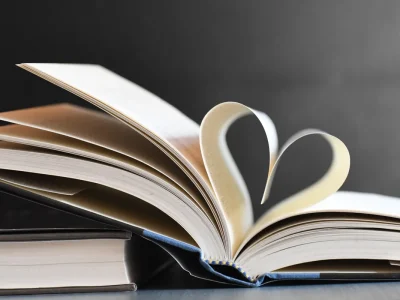 Open book with pages forming a heart, symbolizing love for reading and literature