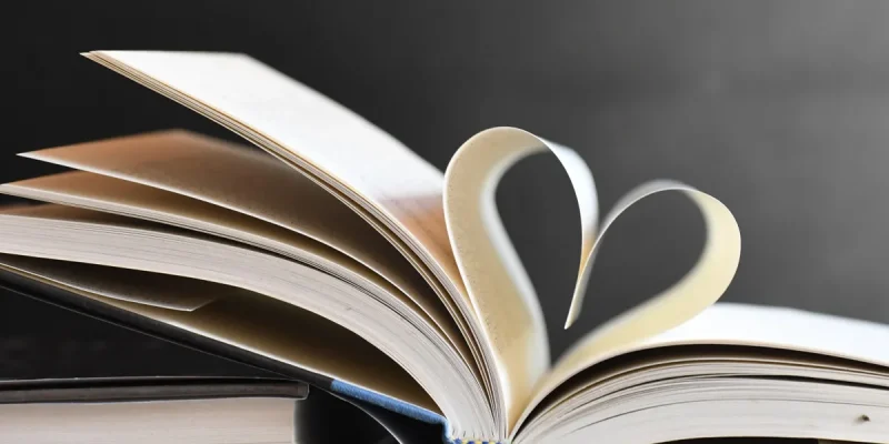 Open book with pages forming a heart, symbolizing love for reading and literature