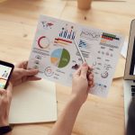 Industry Fluency Separates Standout Search Agencies From the Rest of the Field: marketing specialists reviewing SEO and campaign analytics charts at a desk