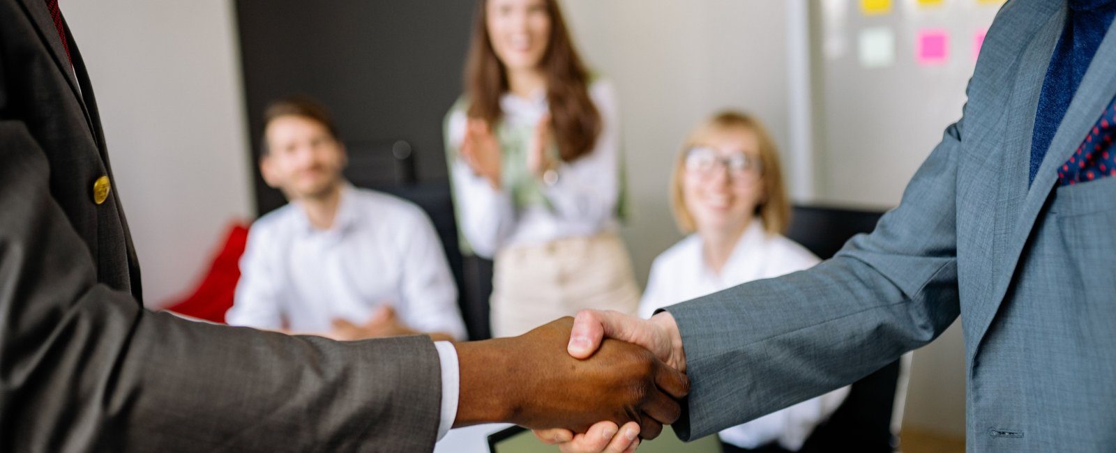 Two colleagues shaking hands in an office