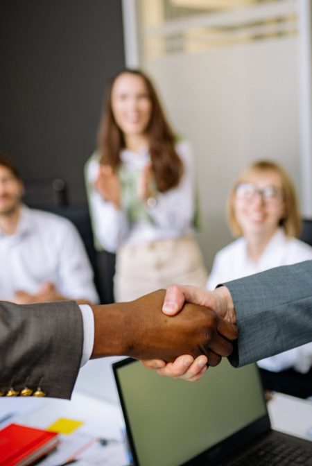 Two colleagues shaking hands in an office